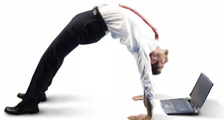 Businessman in white shirt and tie in an arched bridge bending over backwards to work on his laptop
